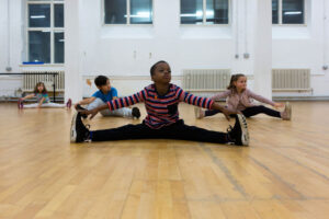 Boy doing splits and stretching
