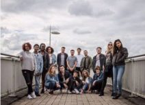 Promotional image for LEVI’S® music lab. Photo of a group of teenagers and young adults. There are railings on either side of them and they are standing outside on what appears to be a bridge over a road.