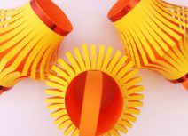 Three orange and yellow hand-made paper lanterns
