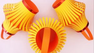 Three orange and yellow hand-made paper lanterns
