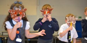 Primary school pupils wearing hand-made masks