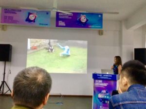 Photo of Natasha Stott presenting a short video clip of site-specific dance in a brutalist urban environment