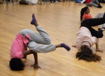 Promo image for Z-Dance. Photo of two teenage girls break dancing in a dance studio