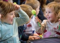 Picture of two preschool age girls smiling at each other
