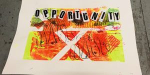 A photo of screenprinting artwork produced by Art Stars participants during students 8 week work-experience placement. It is a rectangular square of canvas with a red, orange, yellow and green pattern printed on it. Black newspaper-like letters spell the word opportunity at the top.