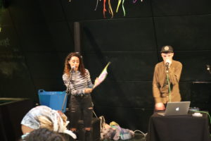 Promo image for Arts and Culture for Teenagers in Manchester - Family Workshop. Photo of a teenage girl and boy holding microphones and singing