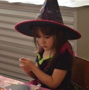 Little girl dressed as witch