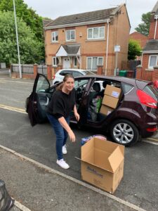 Woman getting boxes out of car