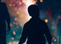 Boy outlined against bonfire