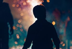 Boy outlined against bonfire