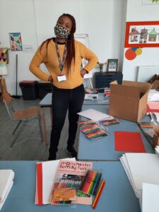 Yemi standing, surrounded by Art Packs
