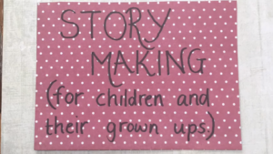 Photo of a piece of pink paper with white spots. On it is written "Story Making (for children and their grown-ups)".