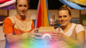 Man and woman holding rainbow box